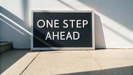 Bold motivational message displayed on a black letter board with sunlight casting shadows on a modern minimalist background