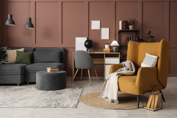 Comfortable armchair, sofa and workplace in interior of living room, closeup