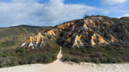 Aerial photography of the Pinnacles in Fraser Island, are a collection of sand dunes that stick up in strange spires and towers. You can see multi-colored sand layers within the dunes themselves.