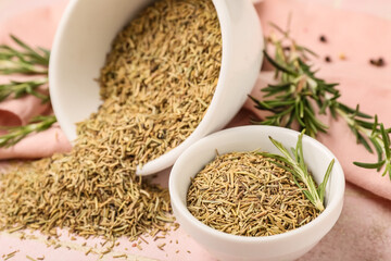 Bowls with dried rosemary on pink background, closeup