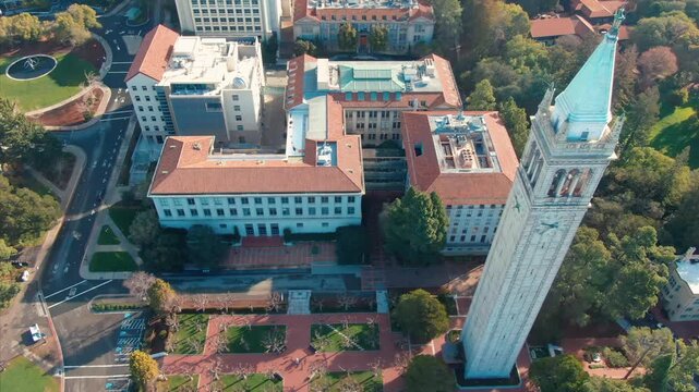 Aerial view of UC Berkeley's iconic Campanile clock tower and campus buildings, showcasing the university's architecture and urban setting in California, USA.