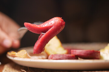 Enjoying a delicious meal featuring a red sausage dish