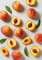Naklejka premium Ripe Peaches and Green Leaves Flatlay on Grey Background