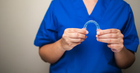 Dentist holding clear aligner orthodontic splint - Dental care and teeth correction treatment
