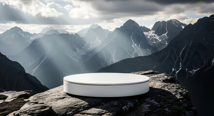 Modern white circular podium on a rocky cliffside, a majestic mountain range provides a dramatic natural backdrop for product presentation