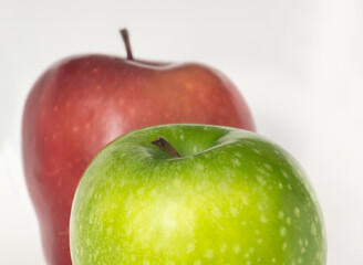 Part of green apple and blurred red