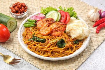 Mie Aceh is a thick yellow noodle dish with spices and shrimp typical of Aceh which is rich in spicy, savory and thick flavor from the curry sauce.