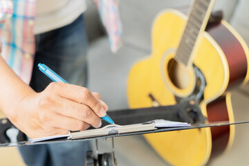 Close up of young man composing music at home. Songwriter having fun enjoy hobby concept