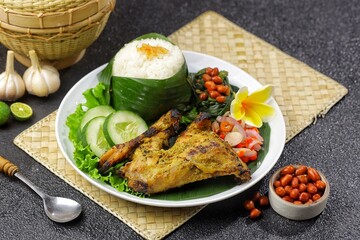 Nasi Ayam Betutu. Betutu Chicken Rice served with plecing kangkung and sambal matah