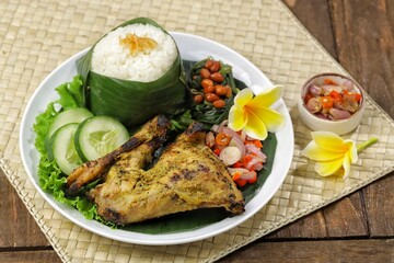 Nasi Ayam Betutu. Betutu Chicken Rice served with plecing kangkung and sambal matah