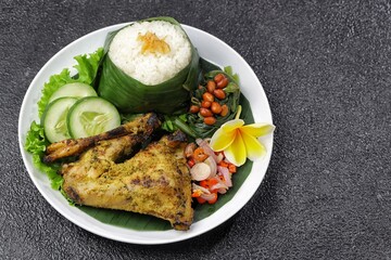 Nasi Ayam Betutu. Betutu Chicken Rice served with plecing kangkung and sambal matah