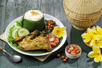 Nasi Ayam Betutu. Betutu Chicken Rice served with plecing kangkung and sambal matah