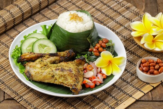 Nasi Ayam Betutu. Betutu Chicken Rice served with plecing kangkung and sambal matah