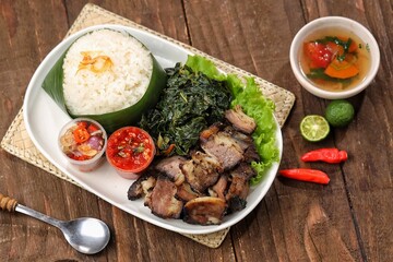 Nasi Ayam Betutu. Betutu Chicken Rice served with plecing kangkung and sambal matah