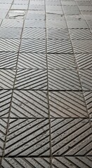 Obraz premium Abstract geometric tile pattern with diagonal line details in stone texture