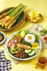 Nasi Campur Bali is a traditional Balinese dish consisting of warm white rice and various side dishes in small portions, such as shredded chicken, sate lilit, lawar, and sambal matah.