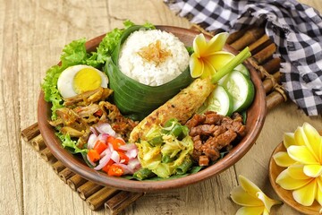 Nasi Campur Bali is a traditional Balinese dish consisting of warm white rice and various side...