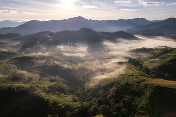Landscape of Morning Mist with Mountain Layer. mountain ridge and clouds in rural jungle bush forest