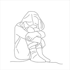 sad girl hugging legs. Girl sitting on the floor hugging her legs. 