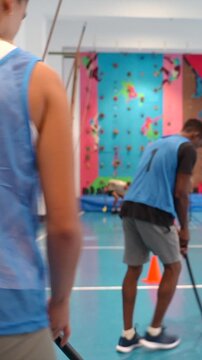 Athletes playing floorball in a gym
