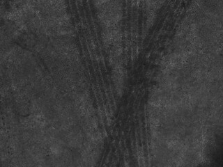 Close up black tire marks on cement floor.