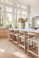 Modern kitchen with wooden bar stools and large windows illuminating autumn landscape