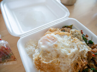 Crispy Pork Basil with Fried Egg in Foam Box Takeaway.