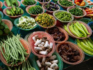 Fresh Vegetables and Herbs on Display at Asian Market Stall.