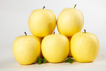 Fresh Golden Yellow Apples with Mint Leaves - Premium Quality Fruit Display