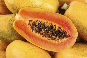 Fresh Cut Papaya with Seeds and Whole Fruits - Tropical Healthy Food Photography