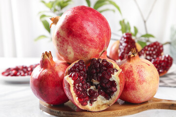 Fresh Red Pomegranates with Seeds on Wooden Board - Healthy Organic Fruit