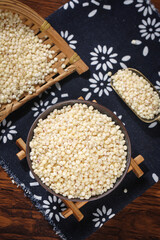 Fresh White Sorghum Grains in Wooden Bowls on Traditional Fabric - Healthy Gluten-Free Cereal Grains