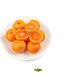 Fresh Small Seedless Tangerines and Satsuma Oranges on White Plate Display