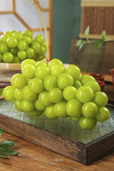 Fresh Green Seedless Grapes on Wooden Tray in Rustic Kitchen Setting