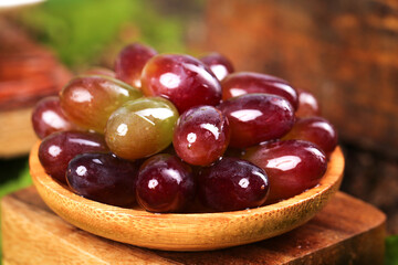 Fresh Red and Green Grapes from Garden in Wooden Bowl on Rustic Table