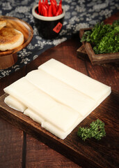Fresh Rice Cake Slices on Wooden Board with Asian Cooking Ingredients