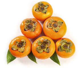 Fresh Fuping Persimmons from Shaanxi China with Green Leaves on White Background