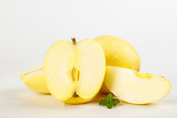 Fresh Aomori Guifei Apples Sliced in Half with Mint Leaf on White Background