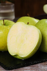 Fresh Green Apples Cut in Half on Dark Slate Board - Healthy Fruit Food Photography