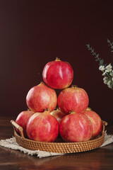 Fresh Red Pomegranates in Wicker Basket - Healthy Organic Fruit Still Life