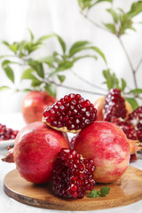 Fresh Pomegranates with Ruby Red Seeds on Wooden Board - Healthy Organic Fruit