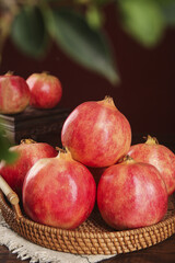 Fresh Organic Pomegranates in Rustic Wicker Basket - Healthy Red Fruit with Natural Kitchen Lighting