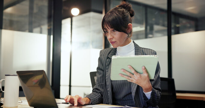 Finance, laptop and tablet with business woman in office for administration or company management. Accounting, app and computer with mature financial manager in corporate workplace for budget review