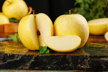 Fresh Yellow Apples from Aomori Liaoning - Whole and Sliced with Mint on Rustic Wooden Background