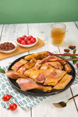 Traditional Air-Dried Hand-Cured Whole Duck Meat Platter with Cherry Tomatoes and Spices on Rustic White Wooden Table