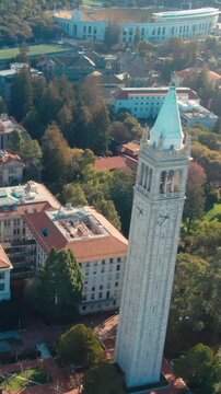 Aerial view of UC Berkeley's iconic Campanile clock tower and campus buildings, showcasing the university's architecture and urban setting in California, USA.