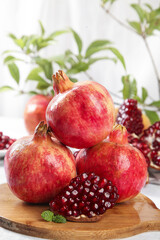 Fresh Tunisian Pomegranates with Seeds Display on Wooden Board - Healthy Organic Fruit