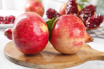 Fresh Tunisian Soft-Seeded Red Pomegranates on Wooden Board with Ruby Arils