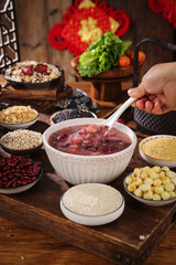 Red Bean Porridge Bowl with Grains and Legumes on Wooden Kitchen Table