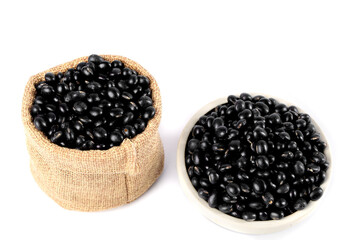 Black sesame beans in burlap sack and bowl - healthy natural grains displayed on white background